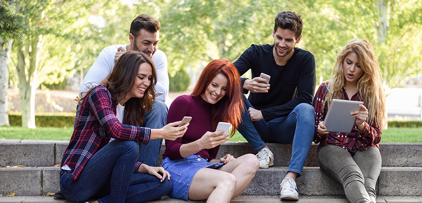 Youth playing with their mobile phones